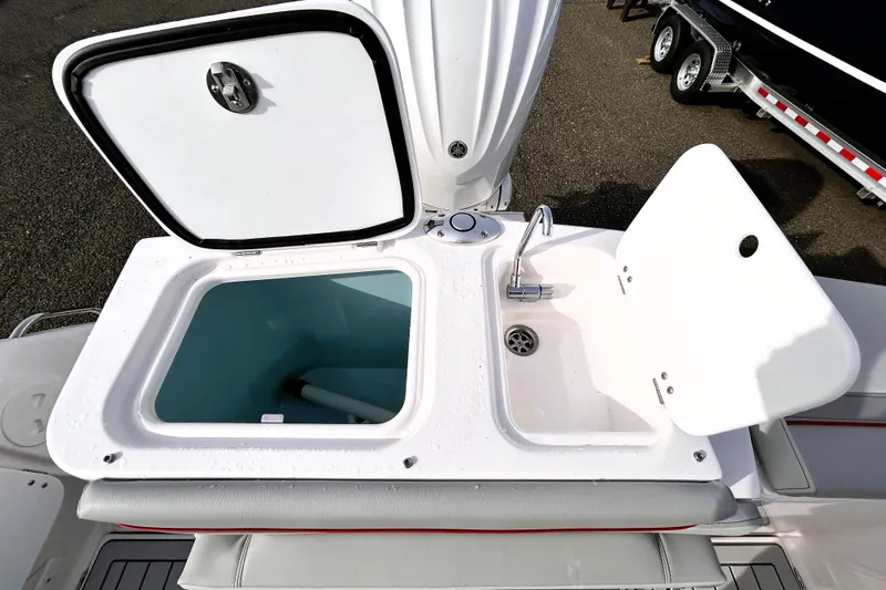 Slide: The Image of Open storage compartment and sink on 2025 Solara S-250 CW boat deck. - 33