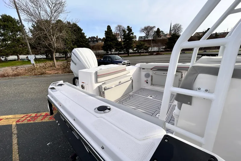 Slide: The Image of 2025 Solara S-250 CW boat with Yamaha engine, parked outdoors near trees. - 35