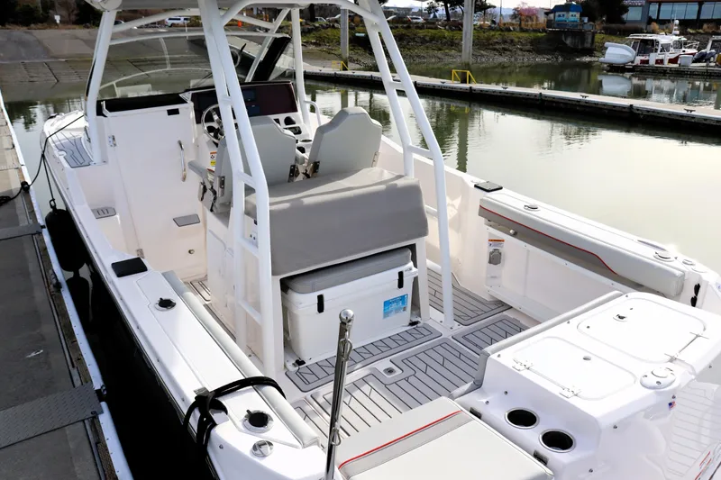 Slide: The Image of 2025 Solara S-250 CW boat interior at dock, featuring seating and storage. - 36