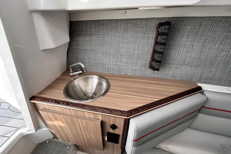 Slide: The Image of 2025 Solara S-250 CW boat interior with wooden countertop and stainless steel sink. - 39