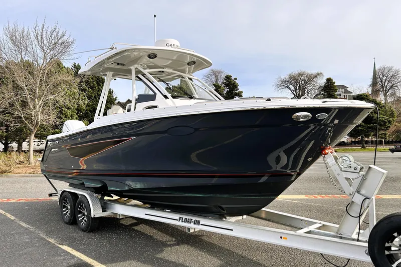 Slide: The Image of 2025 Solara S-250 CW boat on trailer, parked outdoors. - 4