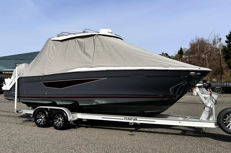 Slide: The Image of 2025 Solara S-250 CW boat on trailer, covered, parked outdoors. - 49