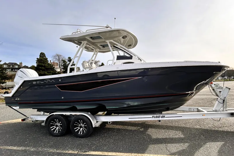 Slide: The Image of 2025 Solara S-250 CW boat on trailer, sleek design, parked outdoors. - 5