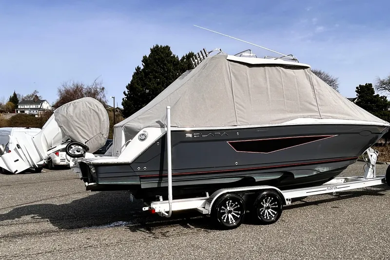Slide: The Image of 2025 Solara S-250 CW boat on trailer, covered, parked outdoors. - 50
