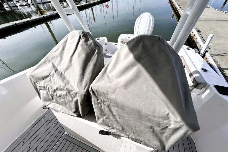 Slide: The Image of Covered seats on a 2025 Solara S-250 CW boat at a marina. - 52