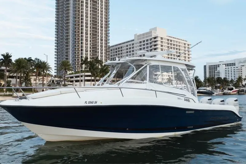 Slide: The Image of 2006 Hydra-Sports Vector 3300 VX boat on water, city skyline background. - 3