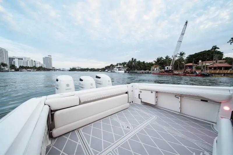 Slide: The Image of 2006 Hydra-Sports Vector 3300 VX boat on calm waters, cityscape in background. - 5