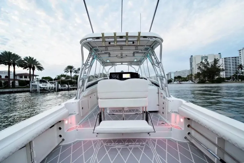 Slide: The Image of 2006 Hydra-Sports Vector 3300 VX boat interior with seating, docked near waterfront buildings. - 6