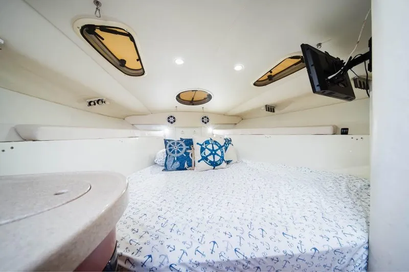Slide: The Image of Interior cabin of 2006 Hydra-Sports Vector 3300 VX with nautical-themed bedding. - 9