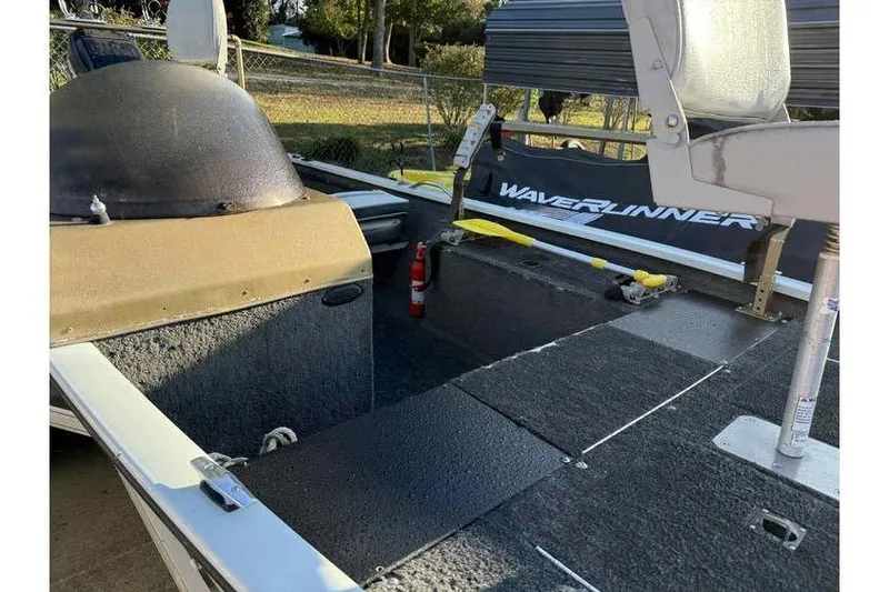 Slide: The Image of 1997 Alumacraft Super Bandit boat interior with seating and storage compartments. - 7