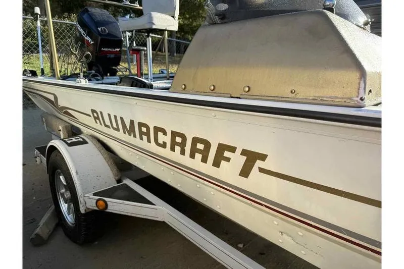 Slide: The Image of 1997 Alumacraft Super Bandit boat on trailer with Mercury outboard motor. - 8