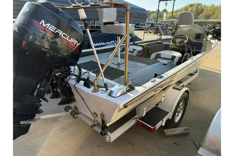 Slide: The Image of 1997 Alumacraft Super Bandit boat with Mercury 75 engine on trailer. - 9