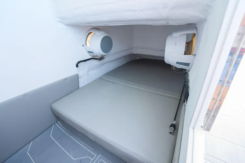 Slide: The Image of Compact cabin interior of 2026 Dynamic D-250DF boat with cushioned seating. - 20