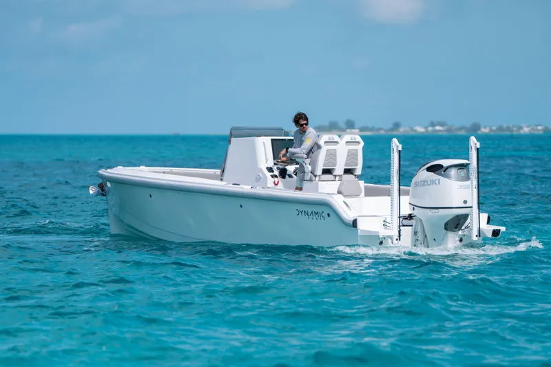 Slide: The Image of A 2026 Dynamic D-250DF boat cruising on clear blue ocean waters. - 28