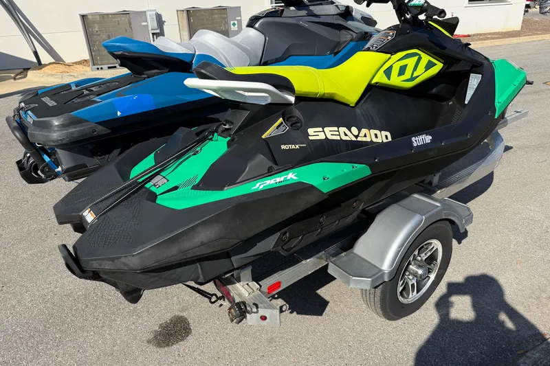 Slide: The Image of 2019 Sea Doo GTX jet ski on trailer, vibrant green and black design. - 4