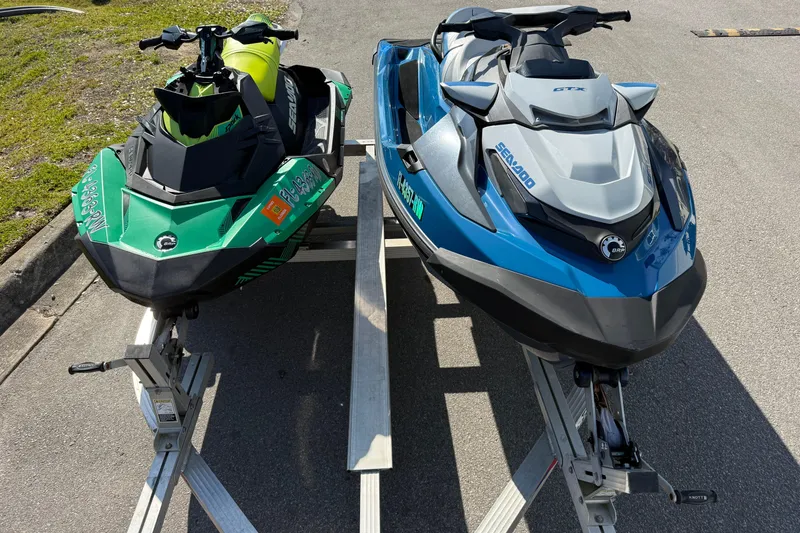 Slide: The Image of Two Sea-Doo jet skis, including a 2019 GTX model, parked on a trailer. - 5