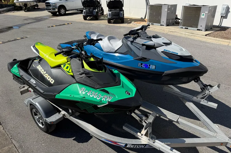 Slide: The Image of Two 2019 Sea-Doo GTX jet skis on a trailer in a parking lot. - 9