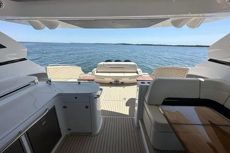 Slide: The Image of 2024 Cruisers Yachts 50 GLS interior with ocean view, featuring luxurious seating and modern amenities. - 10