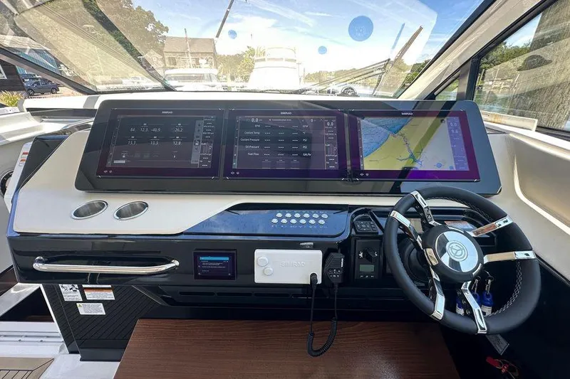 Slide: The Image of Helm of 2024 Cruisers Yachts 50 GLS with advanced navigation displays and controls. - 18