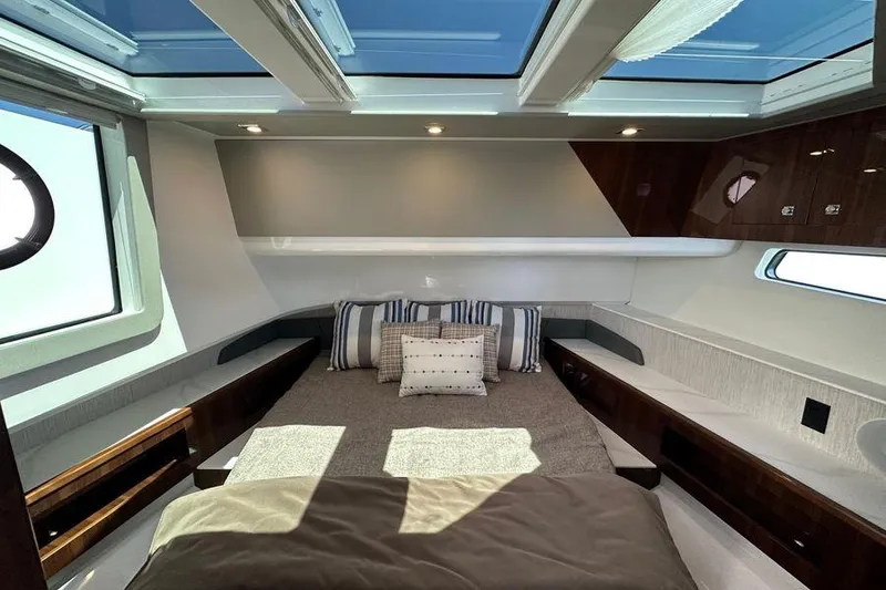 Slide: The Image of Luxurious 2024 Cruisers Yachts 50 GLS cabin interior with skylights and elegant bedding. - 21
