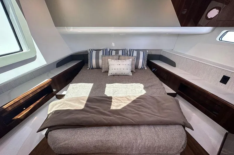 Slide: The Image of Luxurious bedroom interior of 2024 Cruisers Yachts 50 GLS with modern design and cozy bedding. - 22