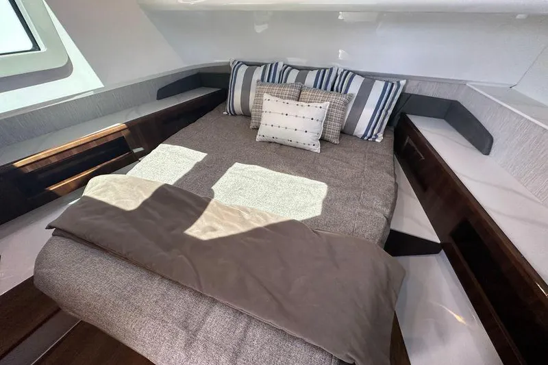 Slide: The Image of Luxurious cabin interior of 2024 Cruisers Yachts 50 GLS with cozy bedding. - 23