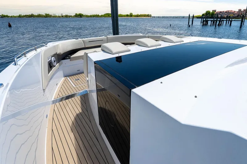 Slide: The Image of 2024 Cruisers Yachts 50 GLS luxury deck with sleek design and waterfront view. - 27
