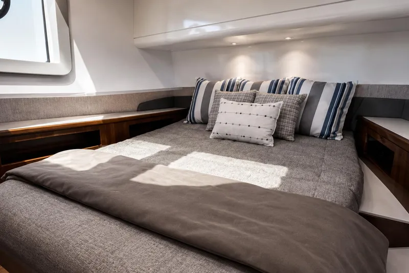 Slide: The Image of Luxurious cabin interior of 2024 Cruisers Yachts 50 GLS with stylish bedding and cushions. - 30