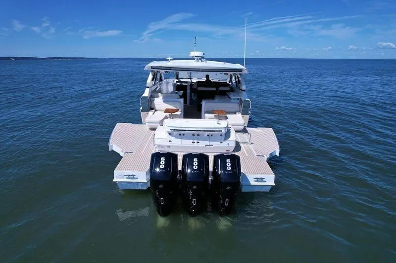 Slide: The Image of 2024 Cruisers Yachts 50 GLS on open water, showcasing powerful engines and spacious deck. - 6