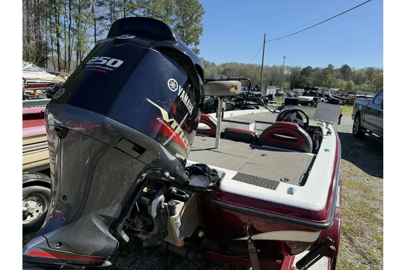 Slide: The Image of 2005 Bumble Bee 2100 boat with Yamaha 250 motor, parked outdoors. - 3