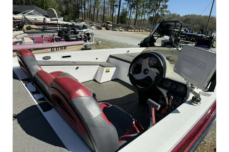 Slide: The Image of Interior of a 2005 Bumble Bee 2100 boat with red and gray seating. - 8