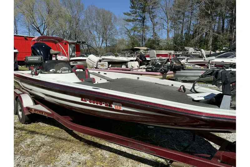 Slide: The Image of 2005 Bumble Bee 2100 boat on trailer, surrounded by other boats in a yard. - 9