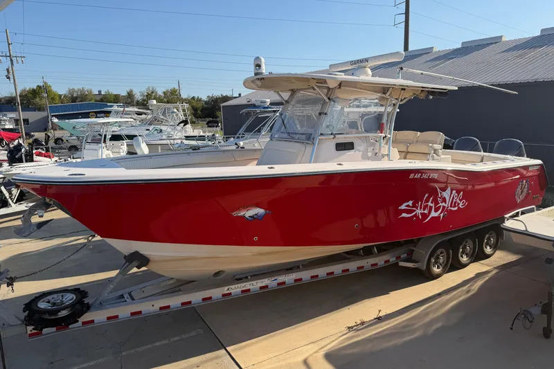 The Image of Red 2010 Grady-White Canyon 366 boat on trailer, parked outdoors. - 0