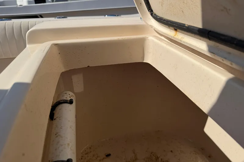 Slide: The Image of Open storage compartment on a 2010 Grady-White Canyon 336 boat, showing interior details. - 12