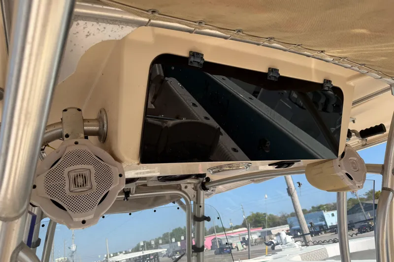 Slide: The Image of 2010 Grady-White Canyon 336 boat console with speakers and storage compartment. - 16