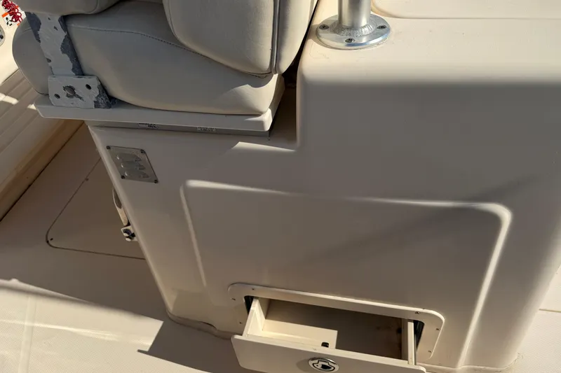 Slide: The Image of 2010 Grady-White Canyon 336 boat interior with seat and storage compartment. - 17