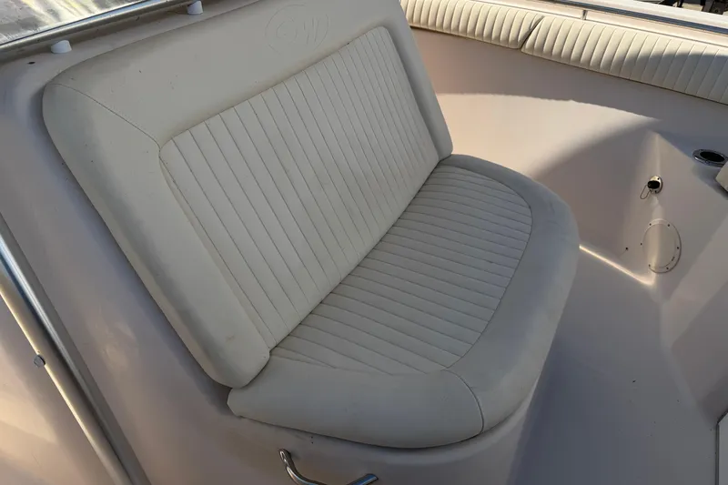 Slide: The Image of 2010 Grady-White Canyon 336 boat seat with white cushioned upholstery. - 20