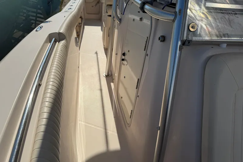 Slide: The Image of 2010 Grady-White Canyon 336 boat deck with railing and storage compartments. - 21