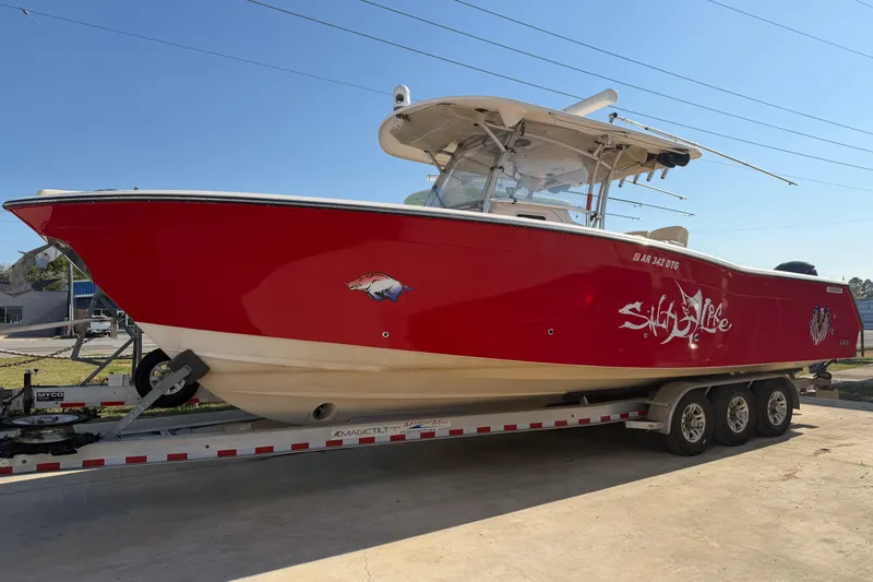 Slide: The Image of 2010 Grady-White Canyon 336 boat in vibrant red on a trailer, side view. - 25