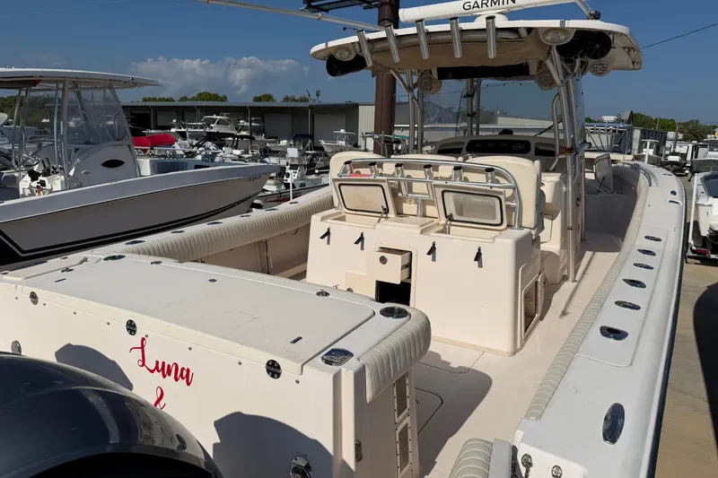 Slide: The Image of 2010 Grady-White Canyon 336 boat docked, featuring spacious deck and Garmin equipment. - 26
