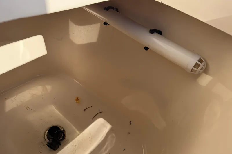 Slide: The Image of 2010 Grady-White Canyon 336 boat interior with drain and rod holder. - 28