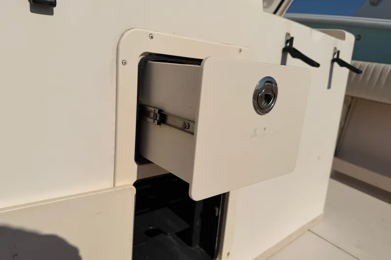 Slide: The Image of Storage compartment on a 2010 Grady-White Canyon 336 boat, partially open. - 32