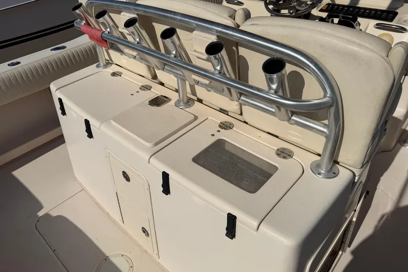 Slide: The Image of 2010 Grady-White Canyon 336 boat interior with rod holders and storage compartments. - 34