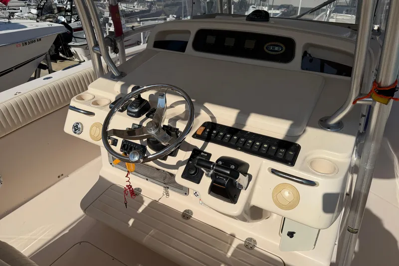 Slide: The Image of 2010 Grady-White Canyon 336 boat helm with steering wheel and controls. - 35