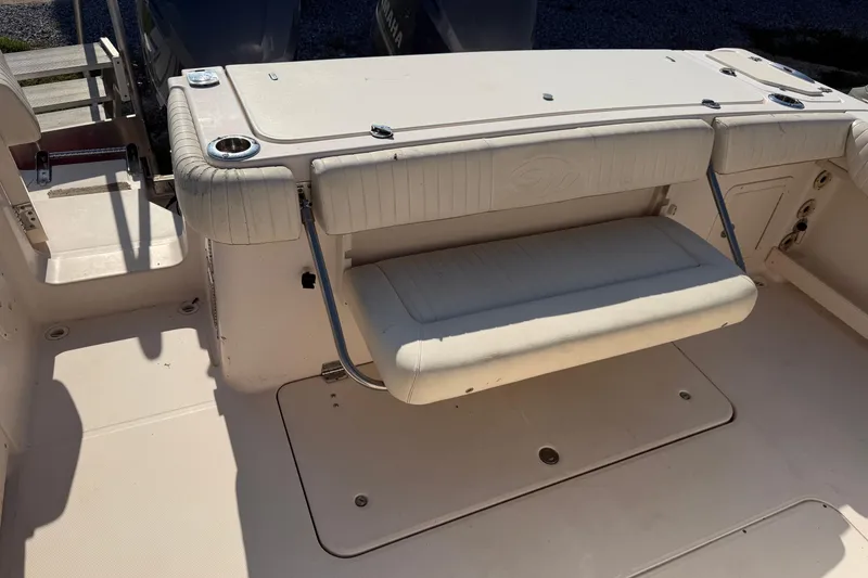 Slide: The Image of 2010 Grady-White Canyon 336 boat interior with foldable seating and cup holders. - 36