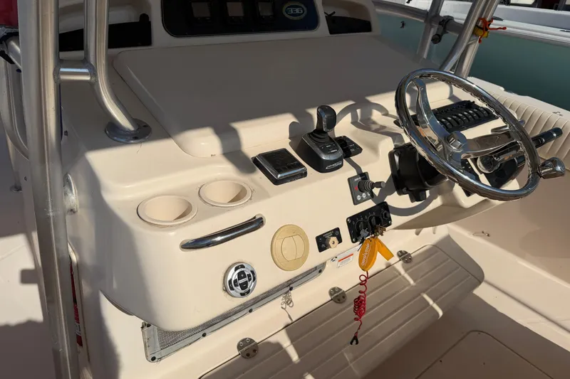 Slide: The Image of 2010 Grady-White Canyon 336 boat helm with steering wheel and controls. - 40