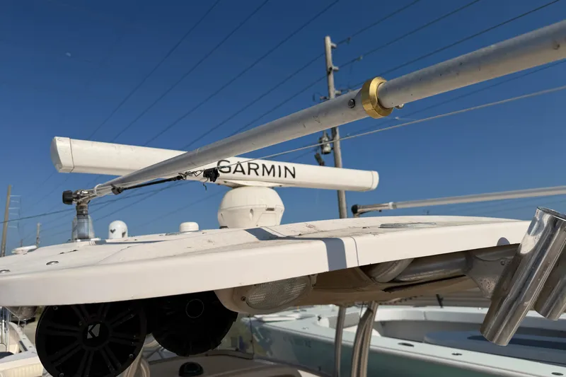 Slide: The Image of 2010 Grady-White Canyon 336 boat with Garmin radar and antennas under clear blue sky. - 43