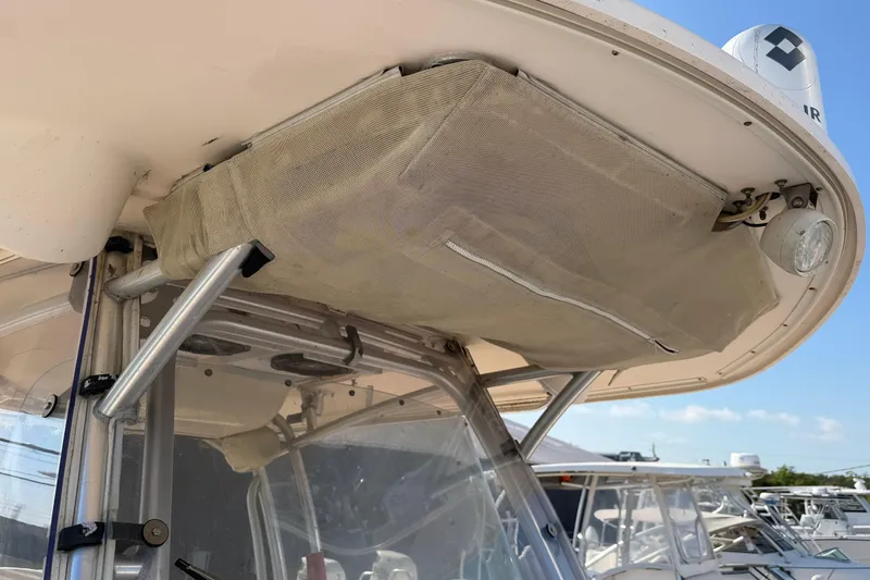 Slide: The Image of 2010 Grady-White Canyon 336 boat with overhead storage and metal supports. - 53