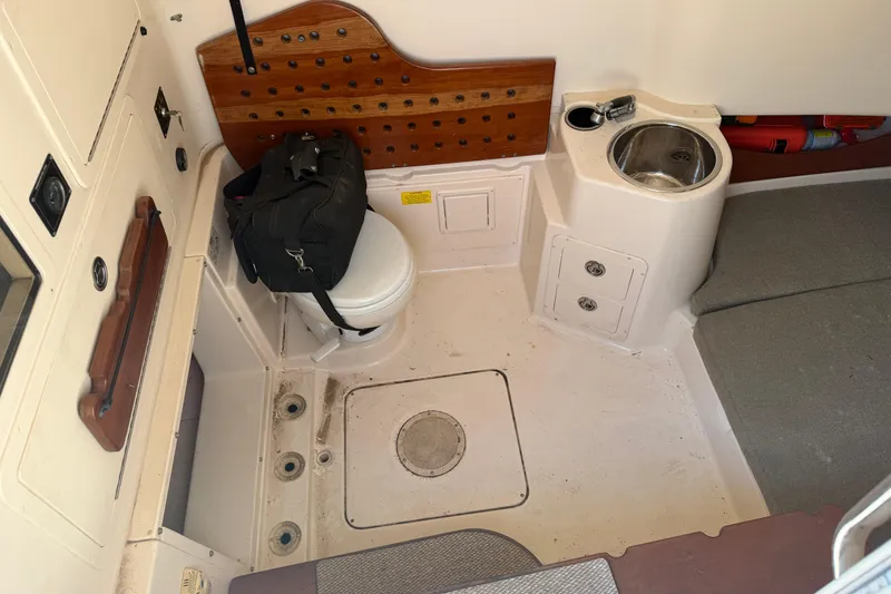 Slide: The Image of Interior of 2010 Grady-White Canyon 336 boat with toilet and sink. - 54