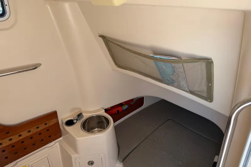 Slide: The Image of 2010 Grady-White Canyon 336 cabin interior with sink and storage net. - 56